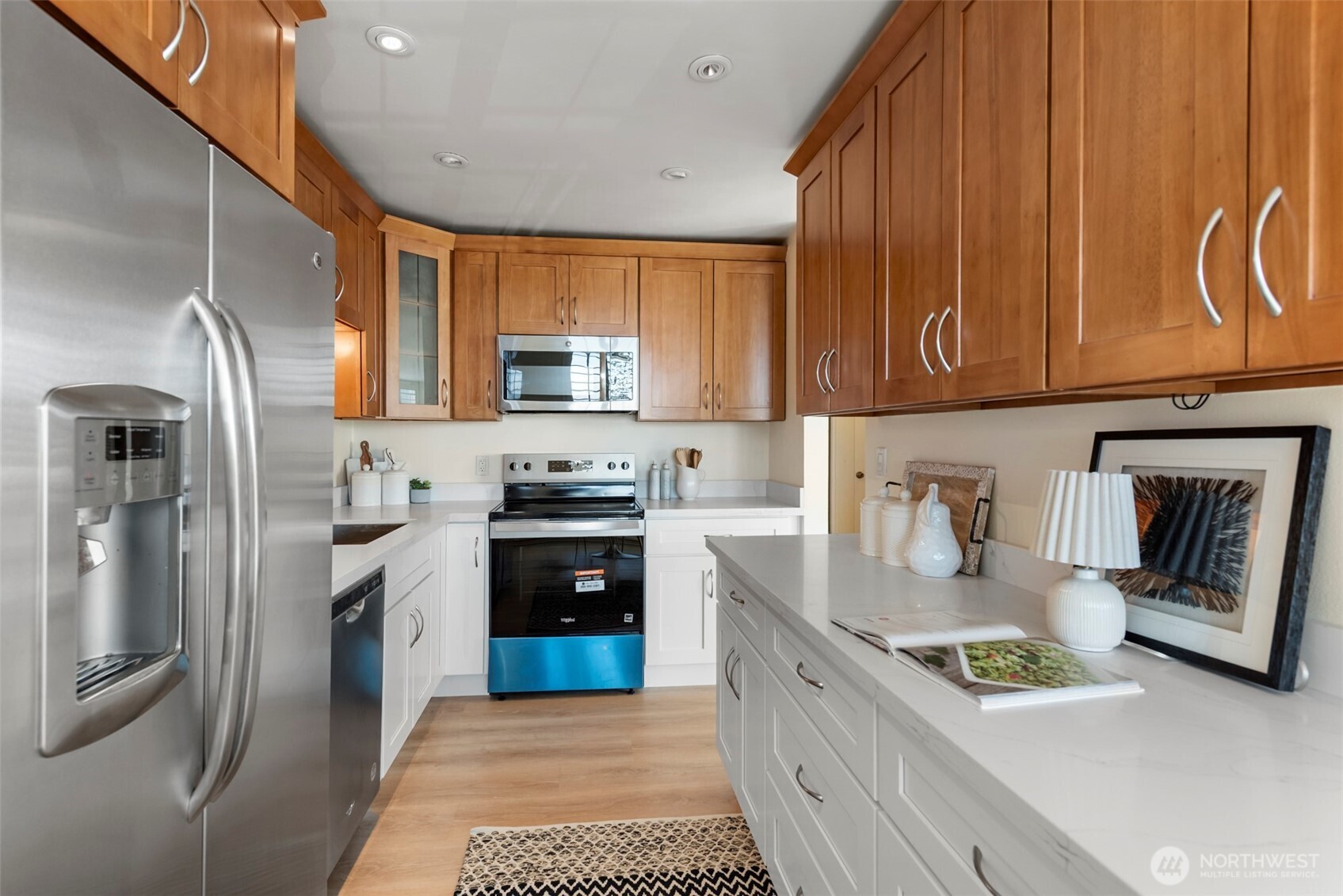 500 West Olympic Place, Unit 203 Seattle, WA 98119 - Photo 10 of 35 a kitchen with stainless steel appliances granite countertop a refrigerator sink and stove