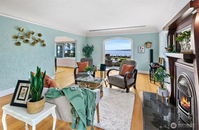 a living room with furniture a fireplace and a window