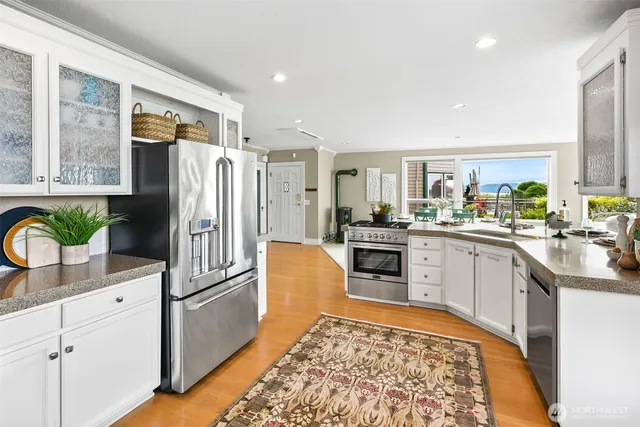 a kitchen with a sink stove and cabinets