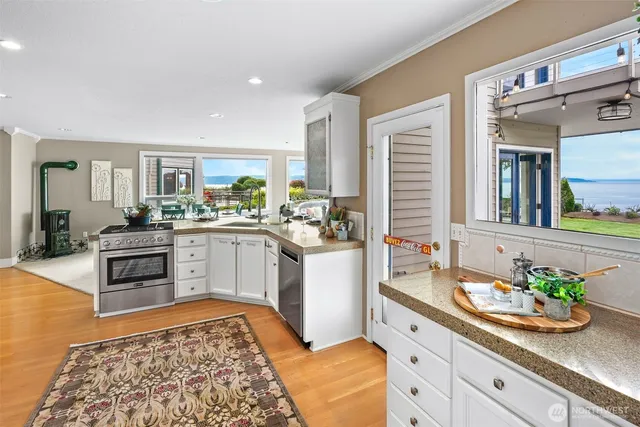 a living room with fireplace furniture and a large window