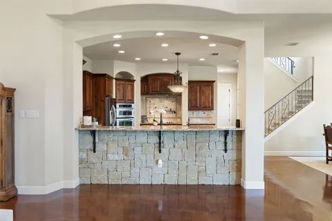 a kitchen with stainless steel appliances granite countertop a stove and cabinets