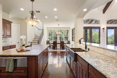 a kitchen with sink stove and cabinets