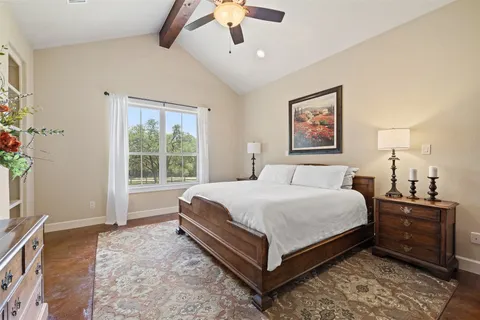 a bedroom with a large bed and a window