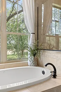 a bathroom with a bathtub and window