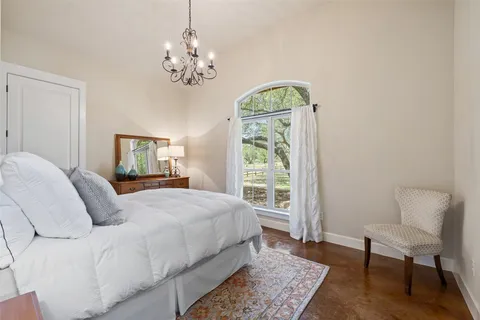 a bedroom with a bed and a chair