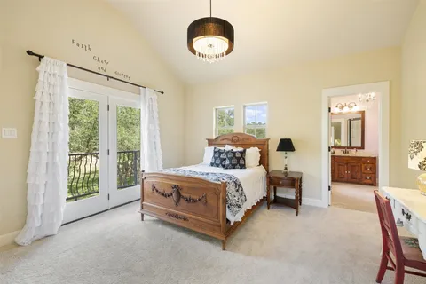 a bed room with a bed and a chandelier