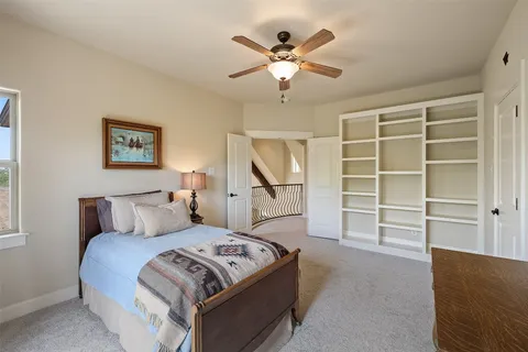 a bedroom with a bed and a chandelier