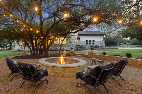 a swimming pool with outdoor seating and yard