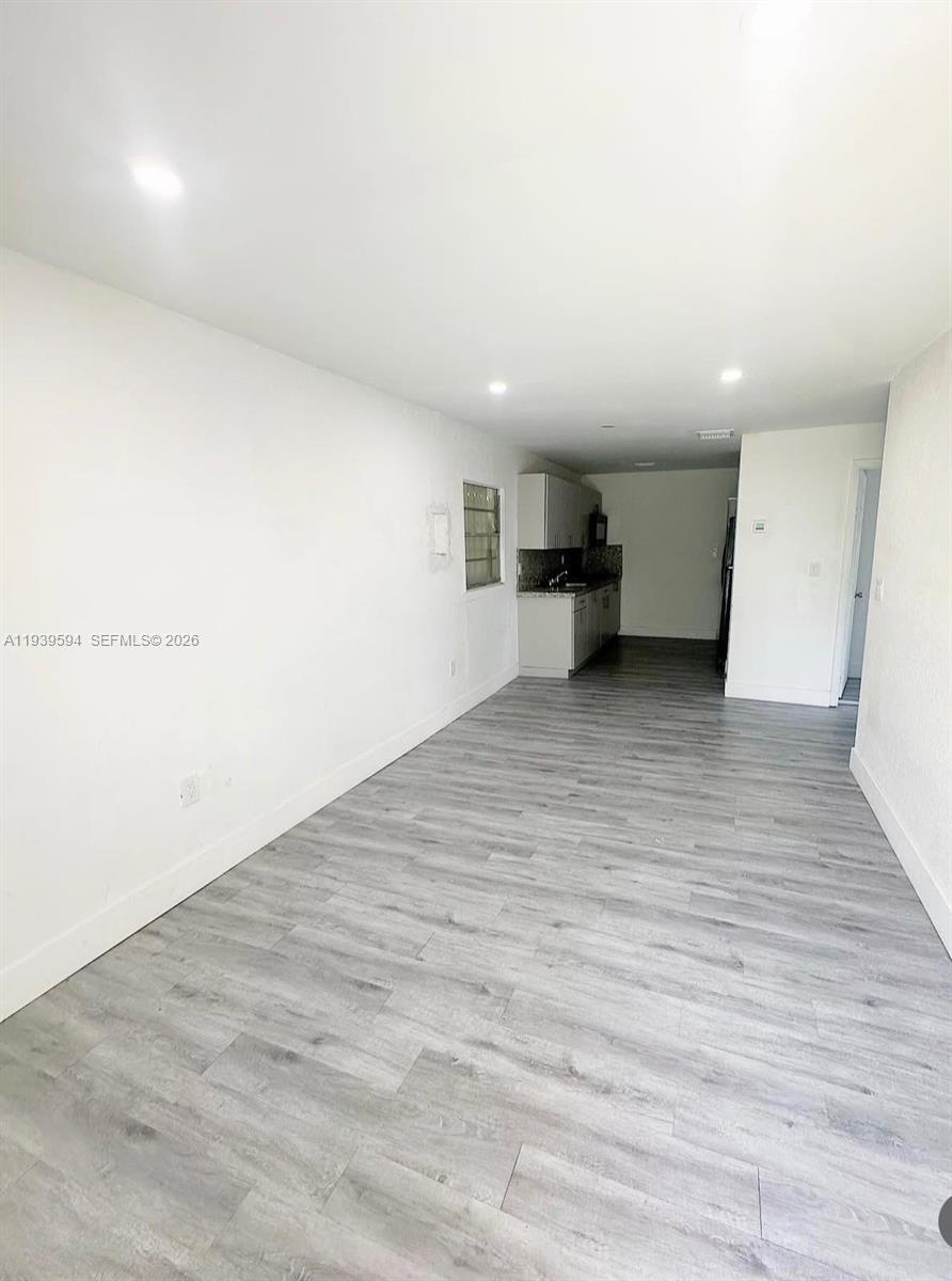 6537 Southwest 39th Terrace Miami, FL 33155 - Photo 12 of 22 a view of a big room with wooden floor and windows