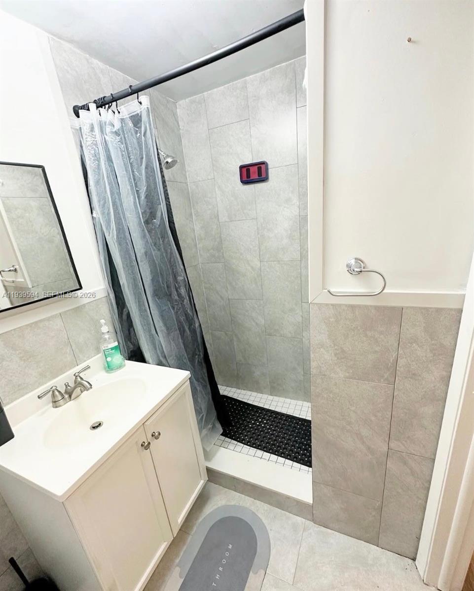 6537 Southwest 39th Terrace Miami, FL 33155 - Photo 22 of 22 a bathroom with a sink and a mirror