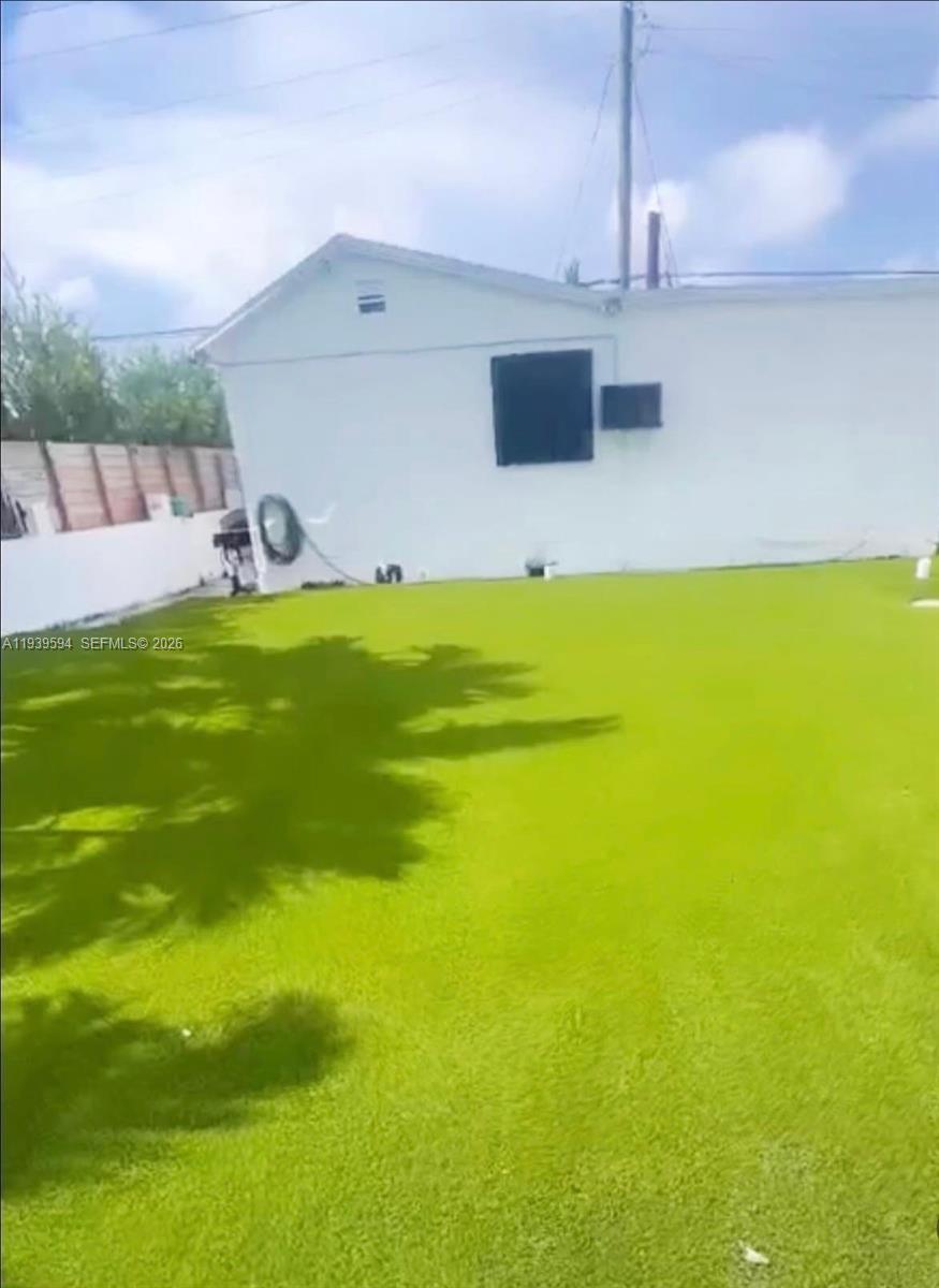 6537 Southwest 39th Terrace Miami, FL 33155 - Photo 3 of 22 a swimming pool with lawn chairs and iron fence