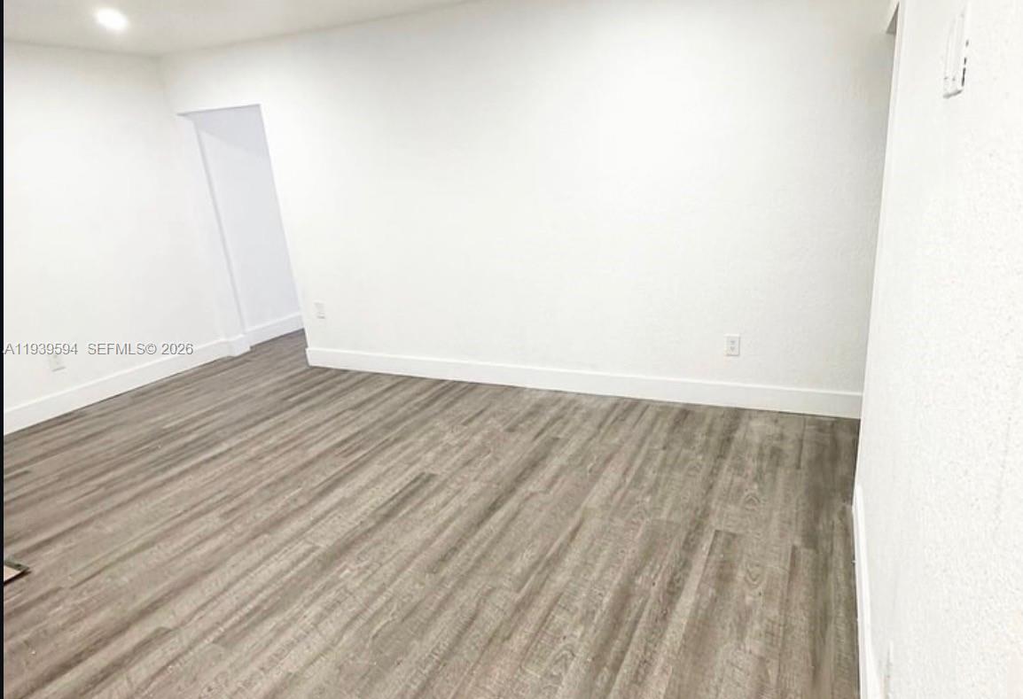 6537 Southwest 39th Terrace Miami, FL 33155 - Photo 5 of 22 a view of an empty room with wooden floor
