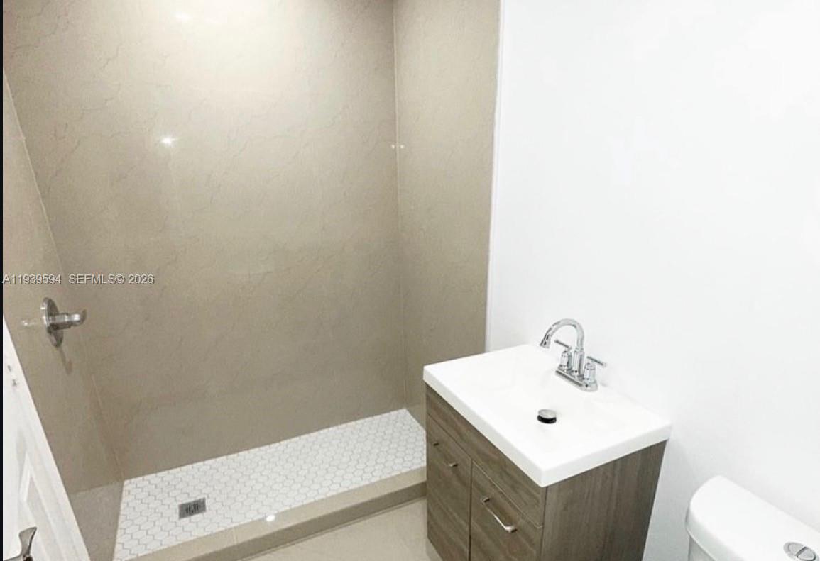 6537 Southwest 39th Terrace Miami, FL 33155 - Photo 8 of 22 a bathroom with a sink a toilet and shower