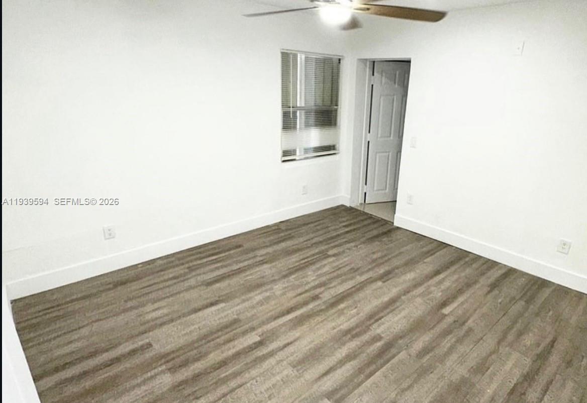 6537 Southwest 39th Terrace Miami, FL 33155 - Photo 10 of 22 an empty room with wooden floor and windows