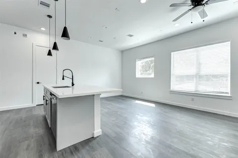 a view of a kitchen with a sink hardwood floor and a window