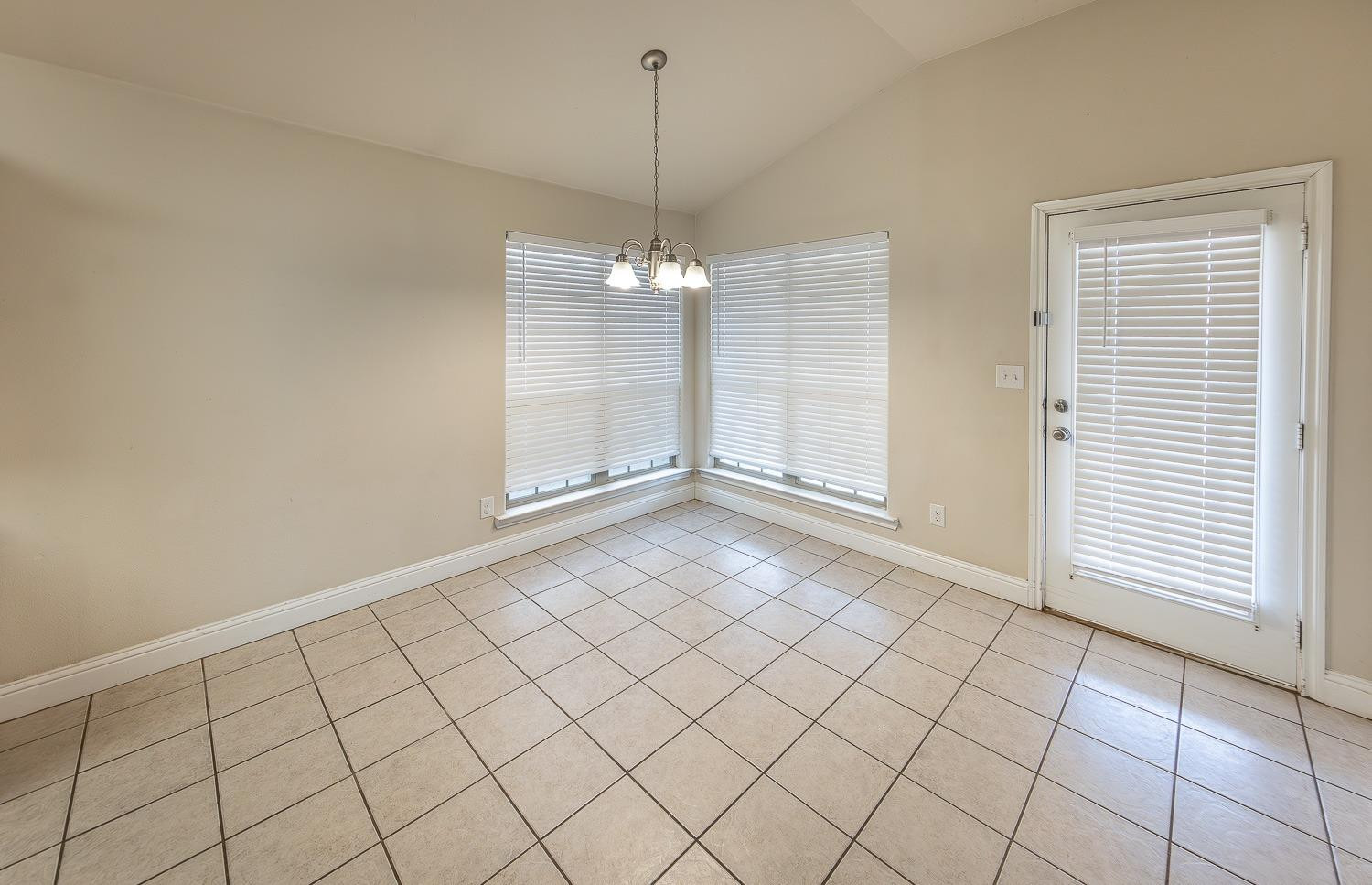 5504 110th Street Lubbock, TX 79424 - Photo 8 of 23 an empty room with kitchen view