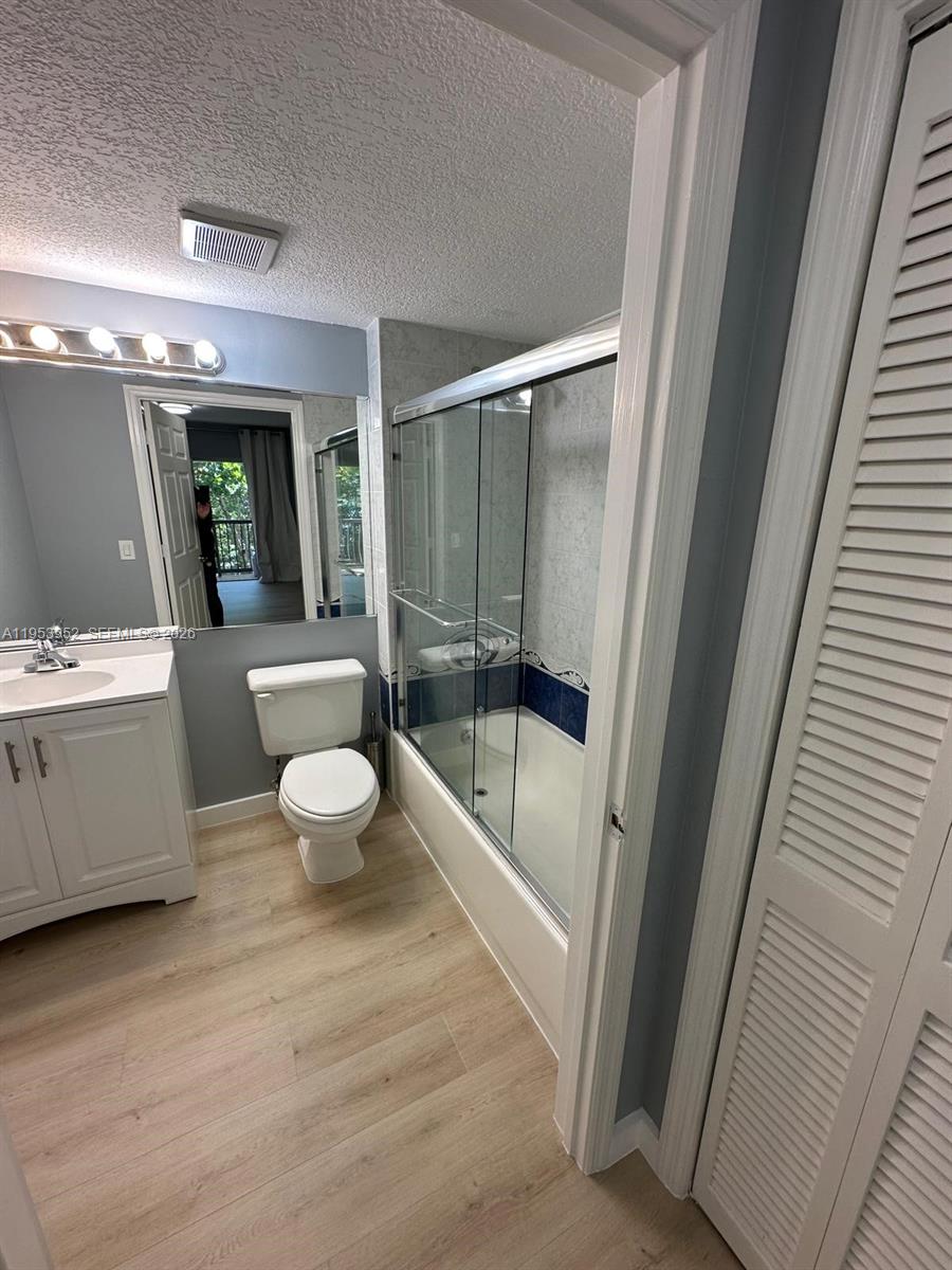 1918 Brickell Avenue, Unit 305 Miami, FL 33129 - Photo 12 of 17 a bathroom with a bathtub shower sink mirror and toilet