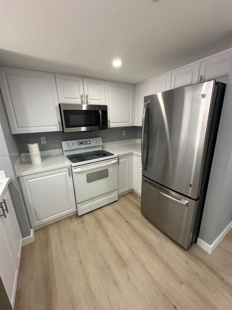 1918 Brickell Avenue, Unit 305 Miami, FL 33129 - Photo 8 of 17 a kitchen with stainless steel appliances a refrigerator sink and microwave