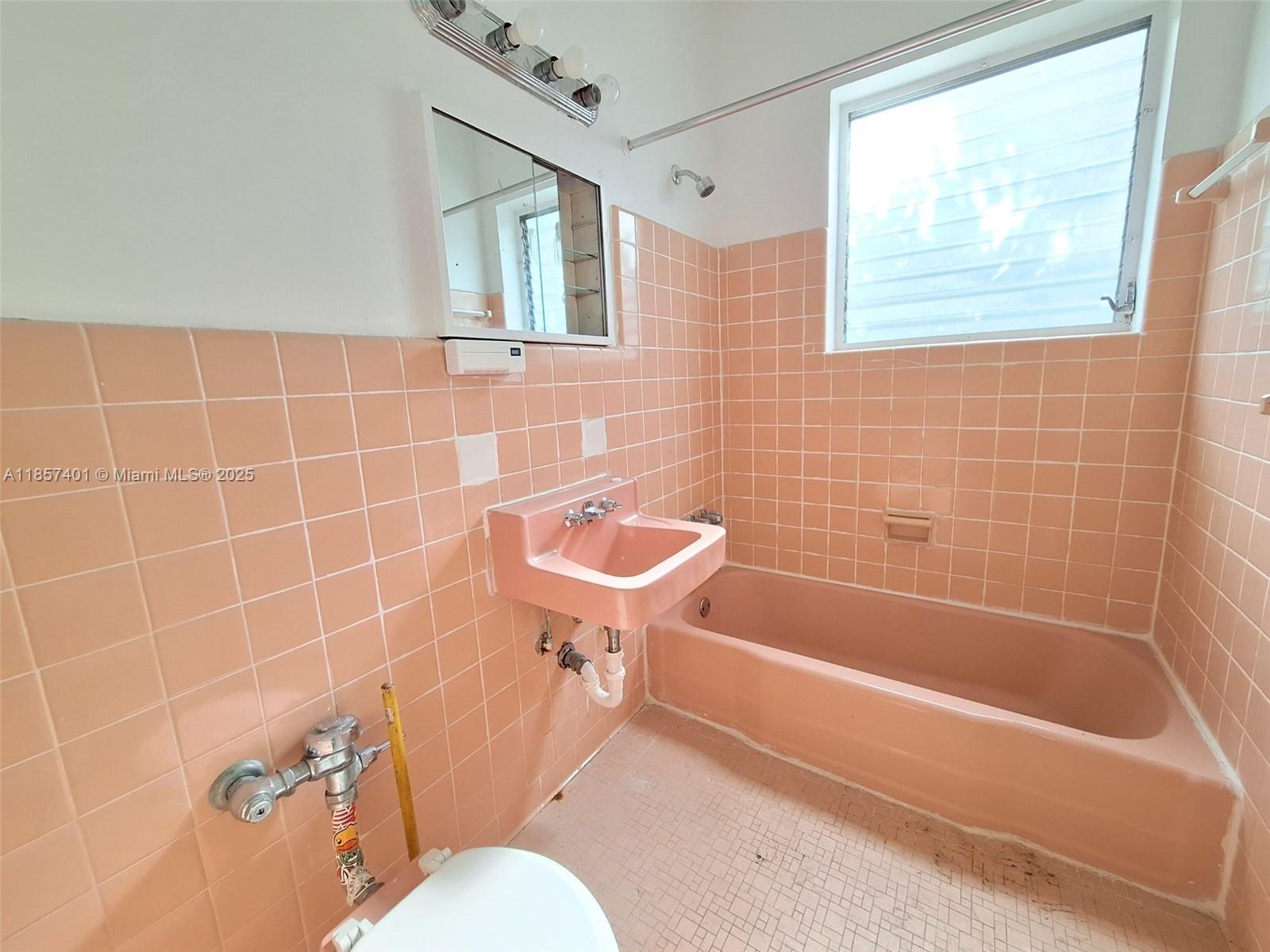 1770 Meridian Avenue, Unit 207 Miami Beach, FL 33139 - Photo 12 of 26 a bathroom with a sink a toilet and bathtub