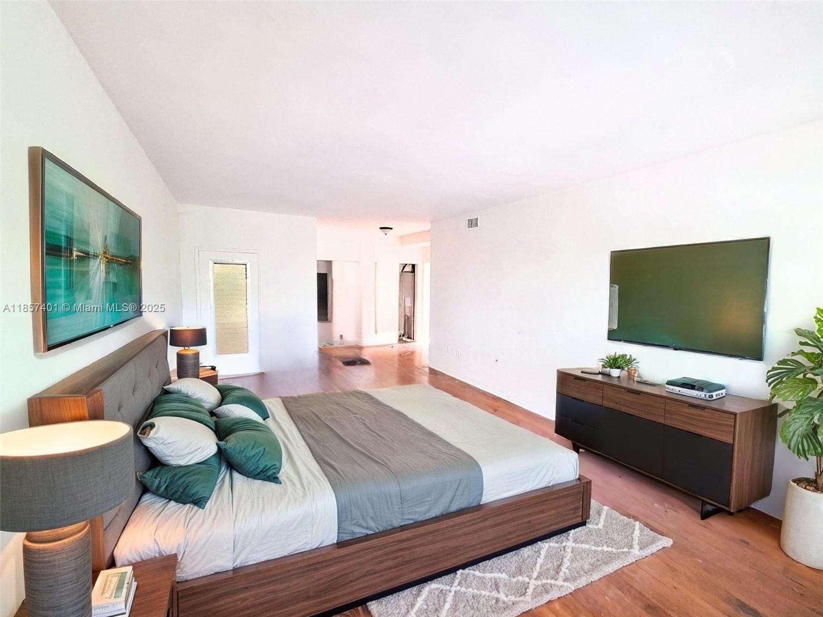 1770 Meridian Avenue, Unit 207 Miami Beach, FL 33139 - Photo 15 of 26 a bedroom with a bed and a flat screen tv