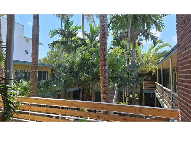 a backyard of a house with plants and outdoor seating