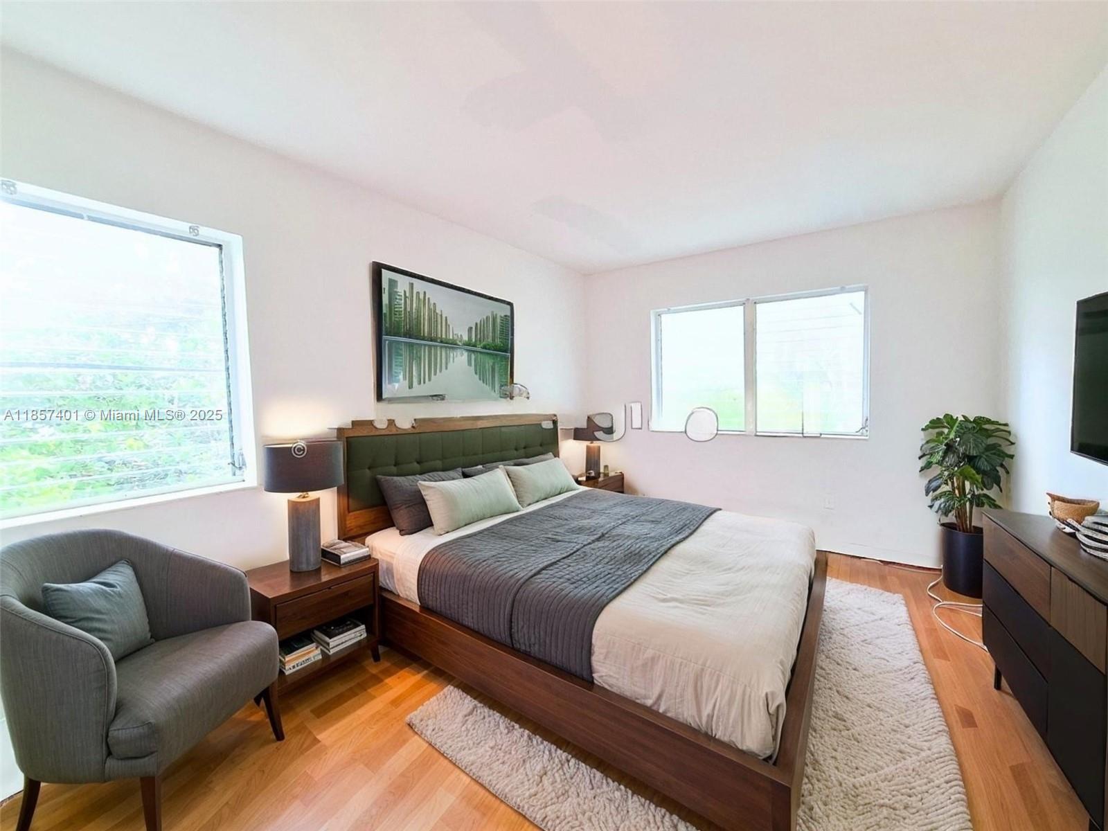 1770 Meridian Avenue, Unit 207 Miami Beach, FL 33139 - Photo 5 of 26 a bedroom with bed couch and window