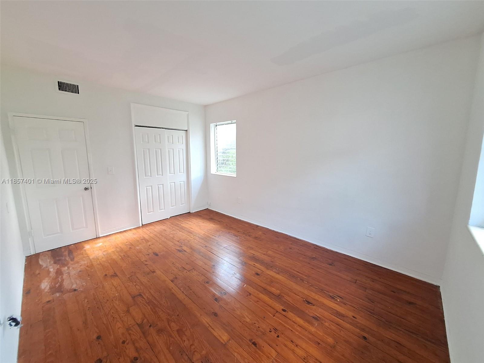1770 Meridian Avenue, Unit 207 Miami Beach, FL 33139 - Photo 6 of 26 a view of empty room with wooden floor and fan