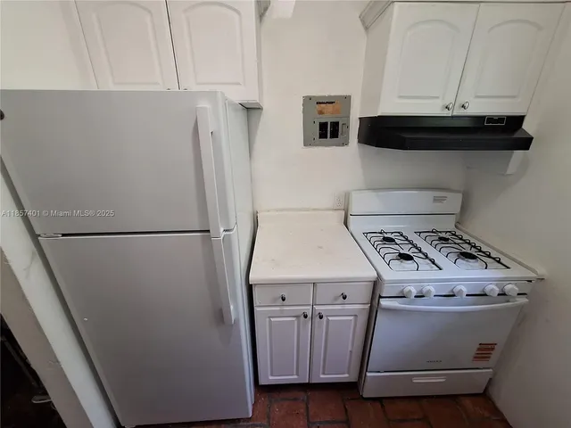 a kitchen with a sink window and cabinets
