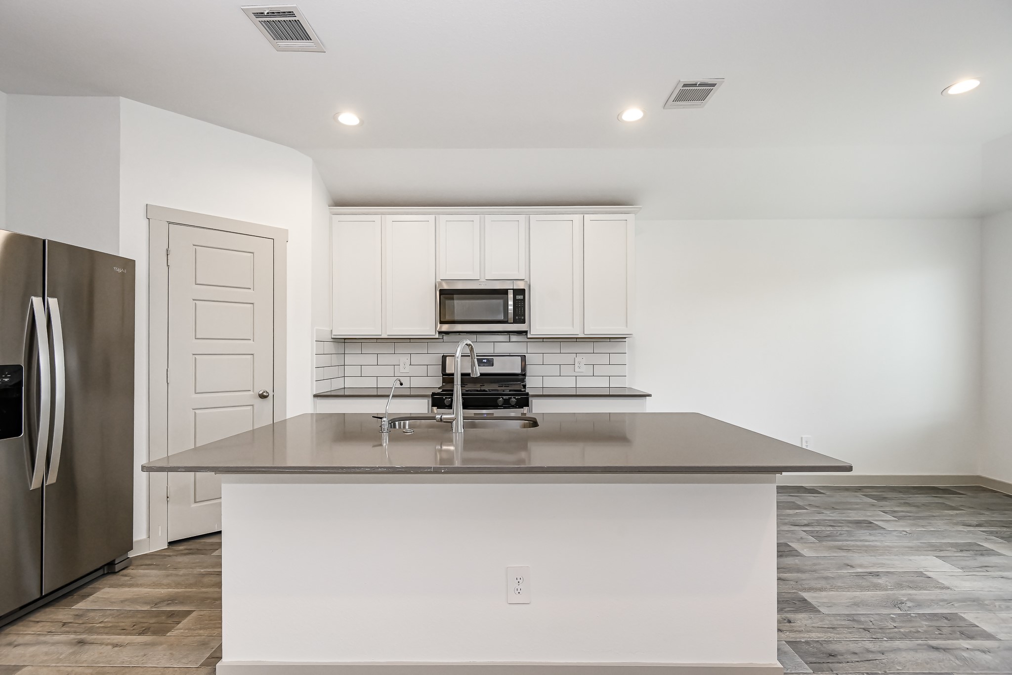 525 Hunter Grove Lane China, TX 77613 - Photo 2 of 27 a kitchen with kitchen island a counter top space cabinets and stainless steel appliances