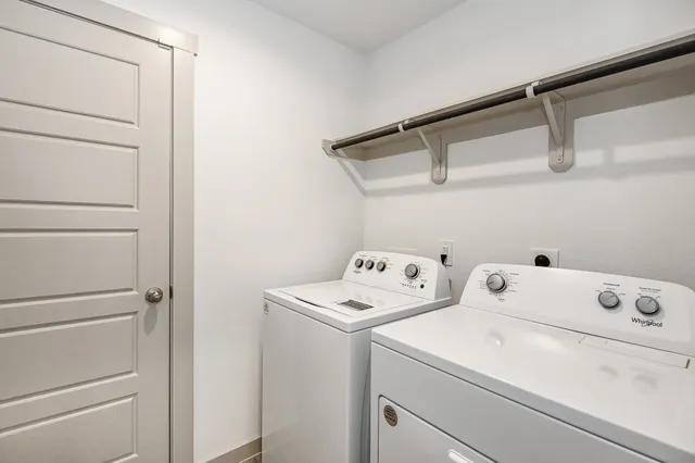 a front view of house with yard and trees in the background