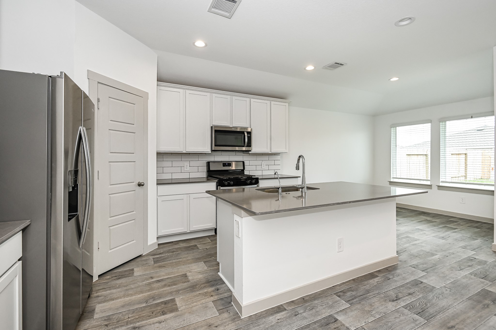525 Hunter Grove Lane China, TX 77613 - Photo 3 of 27 a kitchen with a refrigerator stove and microwave