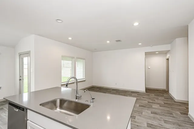 a kitchen with a sink and cabinets