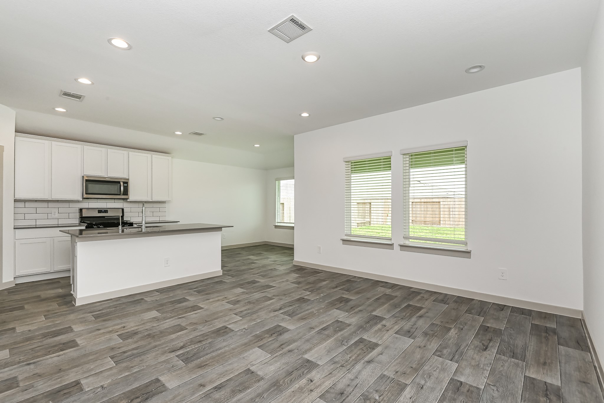 525 Hunter Grove Lane China, TX 77613 - Photo 8 of 27 a large kitchen with stainless steel appliances granite countertop a large stove top oven a sink with dishwasher and cabinets with wooden floor