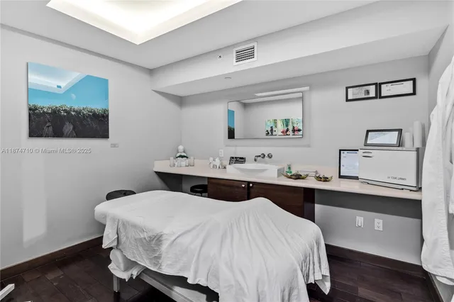 a front view of a house with a yard and fountain in middle