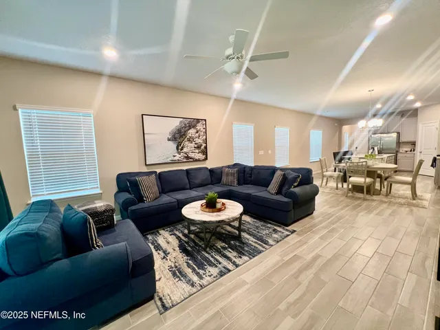 a view of a livingroom with furniture and a ceiling fan