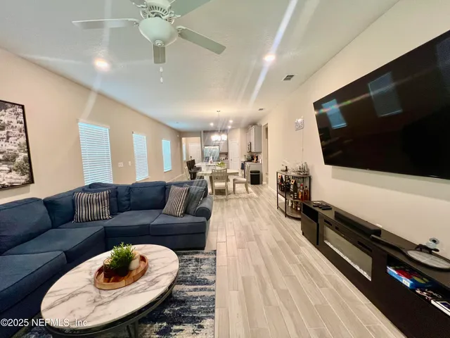 a living room with furniture and a floor to ceiling window