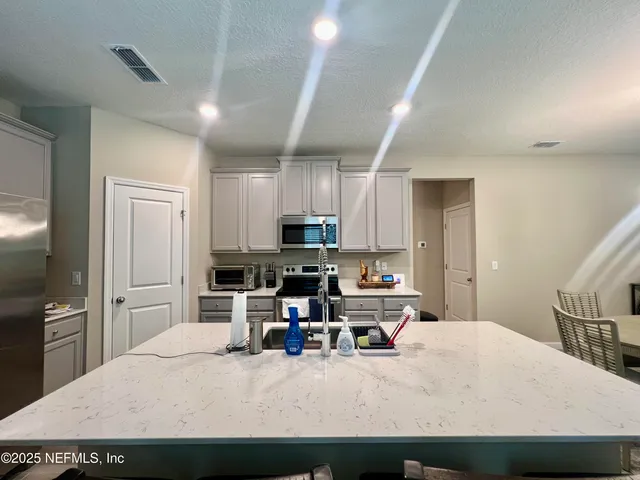 a bathroom with a double vanity sink toilet and shower