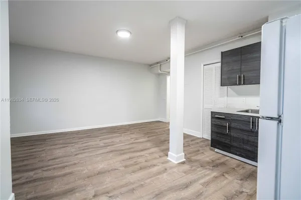 a view of kitchen with wooden floor and electronic appliances