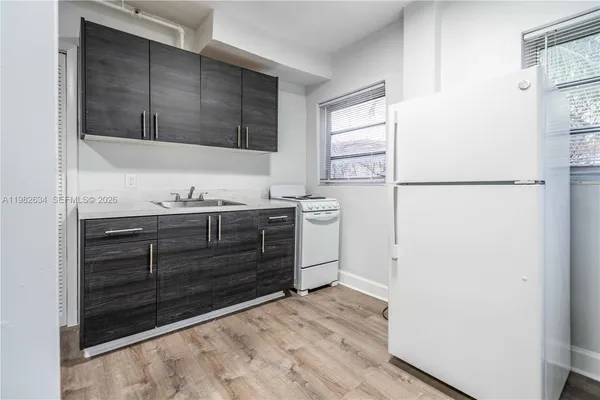 a kitchen with a refrigerator and a sink