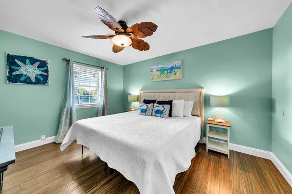 a bathroom with a sink a mirror a toilet and a window