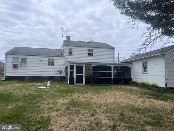 a view of a house with a yard and sitting area