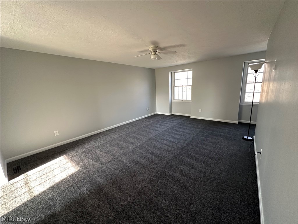 16213 Drake Road Strongsville, OH 44136 - Photo 12 of 28 Unfurnished room featuring dark colored carpet and ceiling fan