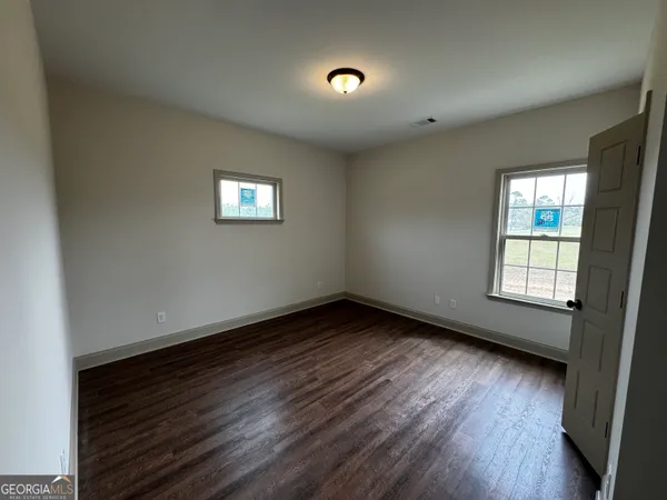 a bathroom with a granite countertop sink a toilet and shower