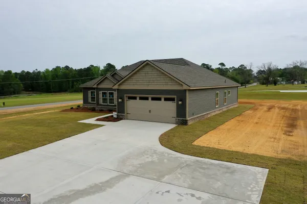 a house with swimming pool in front of it