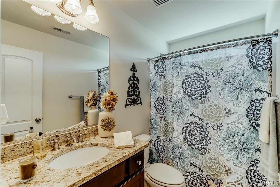 3119 Handley Road Midlothian, VA 23113 - Photo 31 of 41 a bathroom with a granite countertop sink toilet and shower