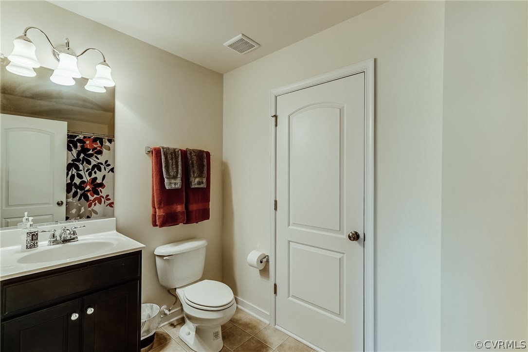 3119 Handley Road Midlothian, VA 23113 - Photo 35 of 41 a bathroom with a toilet sink vanity and mirror