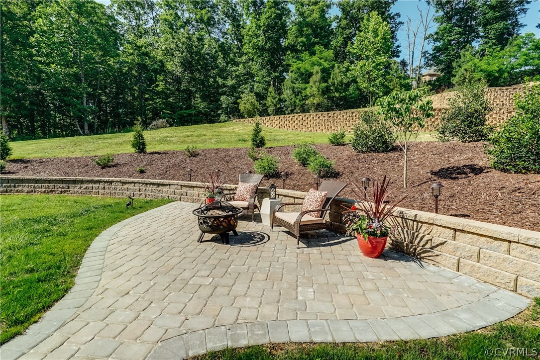 3119 Handley Road Midlothian, VA 23113 - Photo 39 of 41 a view of a backyard with table and chairs potted plants and large tree