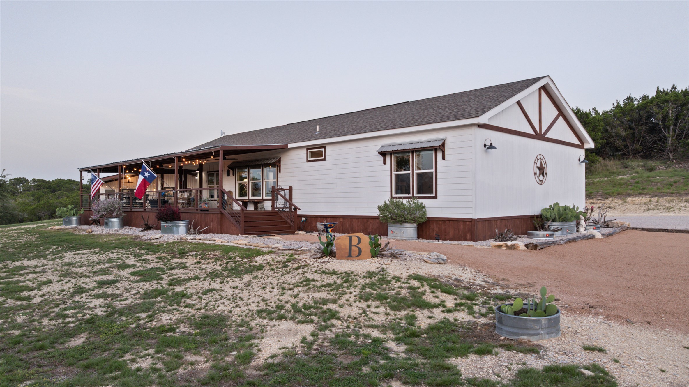830 Ulrich Road Johnson City, TX 78636 - Photo 37 of 40 A charming dwelling with an inviting covered porch perfect for relaxed outdoor living.