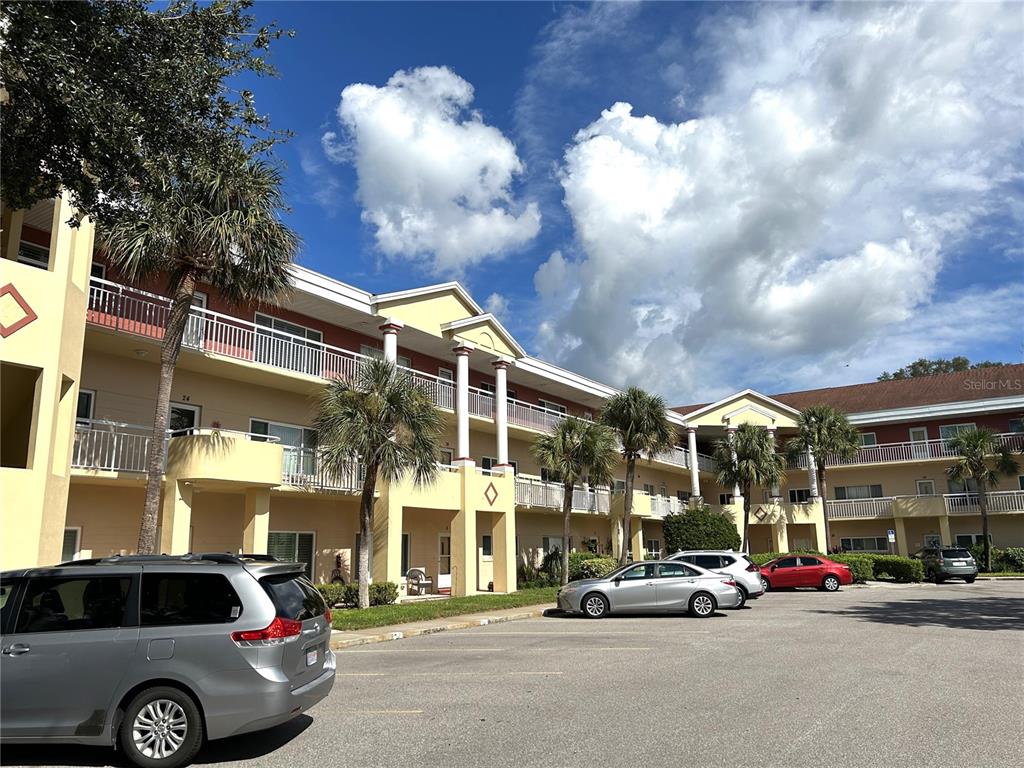 2021 Shangrila Drive, Unit 44 Clearwater, FL 33763 - Photo 1 of 63 a view of a building and car parked on the road