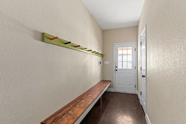 a view of a room with wooden floor and stairs